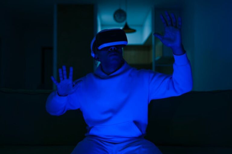Man wearing VR headset enjoying virtual reality experience inside blue-lit room.