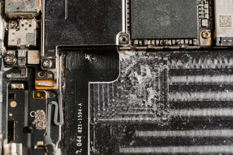 Detailed close-up of a dusty mobile phone circuit board showcasing various electronic components.