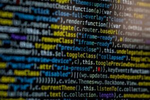 An extreme close-up of colorful programming code on a computer screen, showcasing development and software debugging.