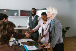 A group of diverse professionals engaged in a collaborative business meeting indoors.