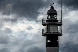lighthouse sky clouds port coast structure tower architecture sea light nature marine