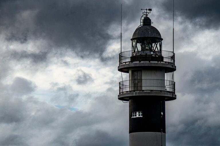 lighthouse sky clouds port coast structure tower architecture sea light nature marine