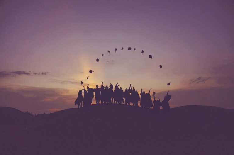 dawn graduates throwing hats dusk nature people silhouette students success sunrise sunset