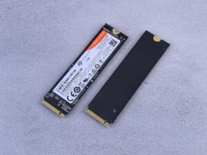 Two NVMe SSDs, Seagate FireCuda, on a gray background for tech enthusiasts.