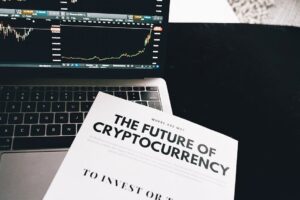A detailed look at cryptocurrency market trends using a laptop and analytical document.