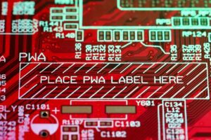 Detailed view of a red printed circuit board (PCB) highlighting a designated area for PWA labeling.
