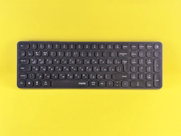 A sleek black wireless keyboard displayed against a vibrant yellow background, perfect for tech themes.