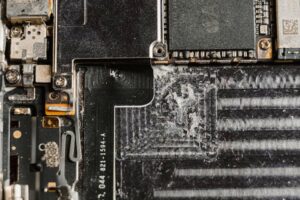 Detailed close-up of a dusty mobile phone circuit board showcasing various electronic components.