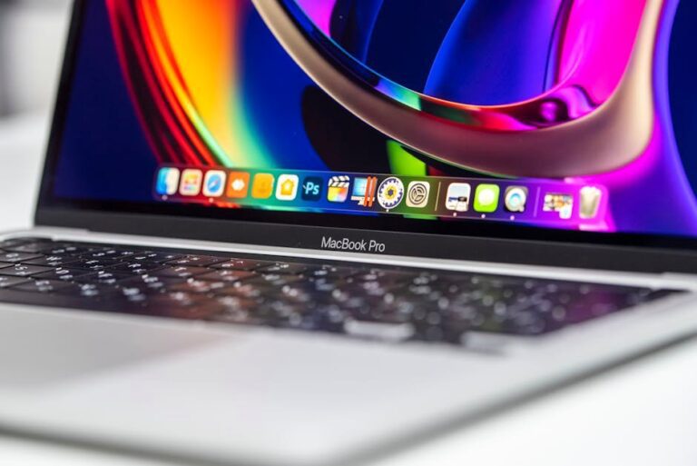 A vibrant close-up of a MacBook Pro showcasing its colorful screen and keyboard.