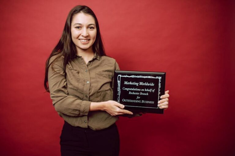 Smiling woman holding an award plaque for outstanding business. Achievement in leadership.