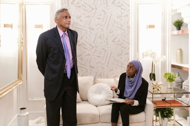 A professional man and woman engage in discussion during a business meeting in a stylish office setting.