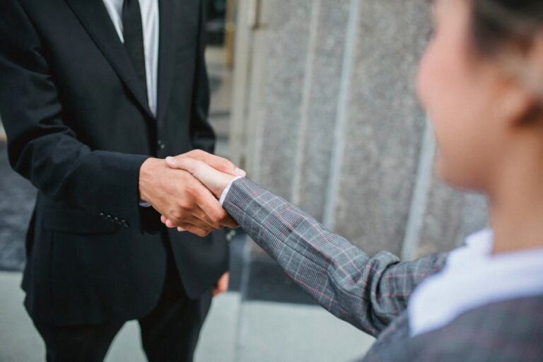 Professional handshake symbolizing partnership and cooperation in a business setting.