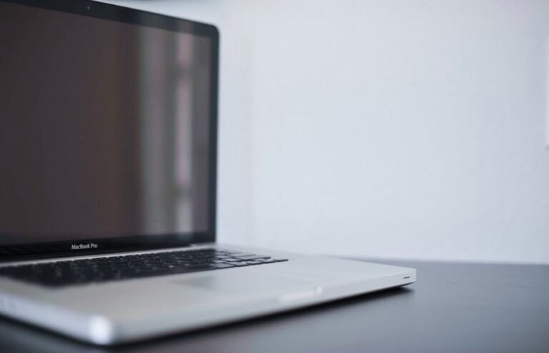 A sleek silver laptop on a modern desk against a white backdrop, perfect for work settings.