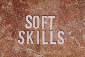 Close-up of the words 'Soft Skills' on a textured stone background for presentations or articles.
