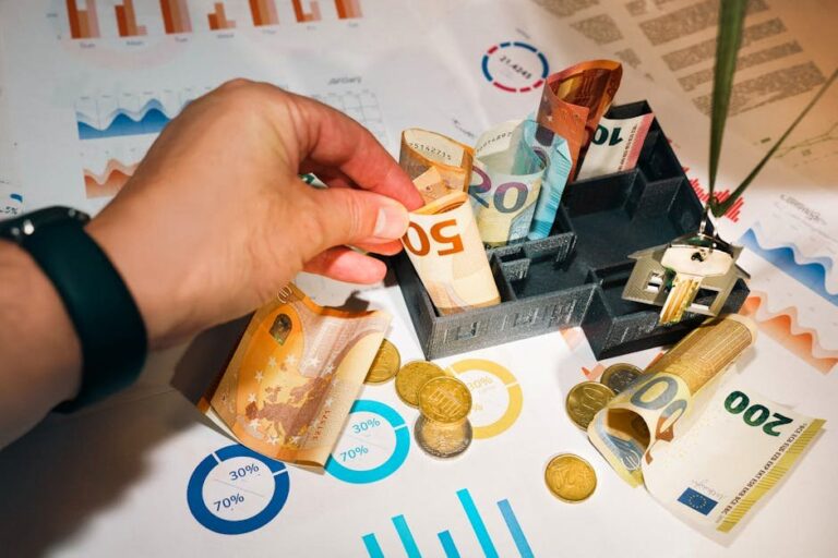 Euro bills and coins with financial charts showcasing budgeting and investment planning.