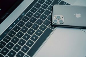 A close-up of a MacBook Pro keyboard and an iPhone showcasing modern technology.