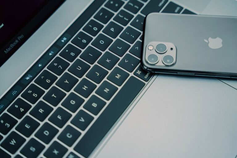 A close-up of a MacBook Pro keyboard and an iPhone showcasing modern technology.