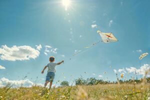 kid kite field darling sunny summer nature liberty play open air blue green fun childhood fly exercise prairie happiness day light landscape clouds air movement