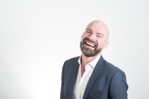 adult bald beard corporate designer suit facial expression fashion laughing male man model outfit professional smile suit tuxedo wear studio photography man man man man man smile