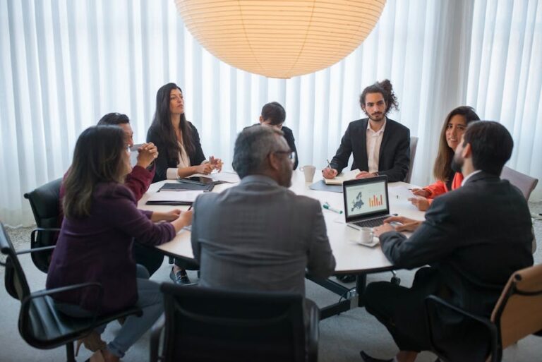 A diverse group of professionals discussing business strategy in a modern office setting.