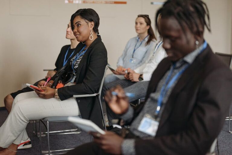 Attendees engaged in a lively business conference session, taking notes and listening attentively.