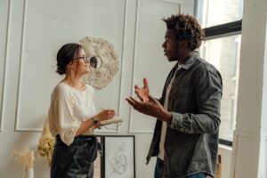A man and woman engaging in a professional consultation in a stylish office setting, highlighting collaboration.