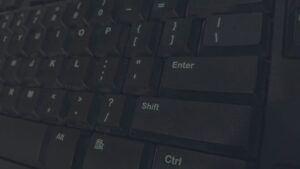 Detailed shot of black computer keyboard showcasing various keys for technology concepts.