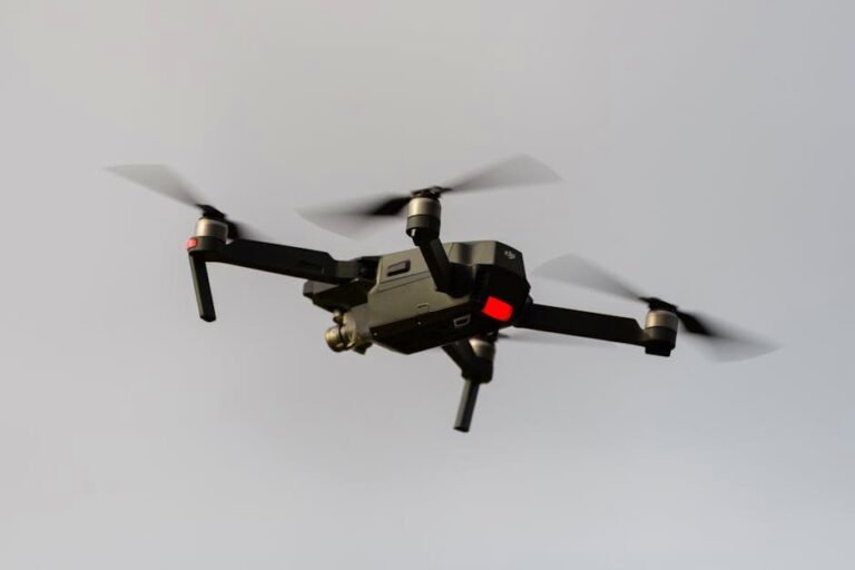 A sleek black quadcopter drone captured in mid-flight, demonstrating modern technology.