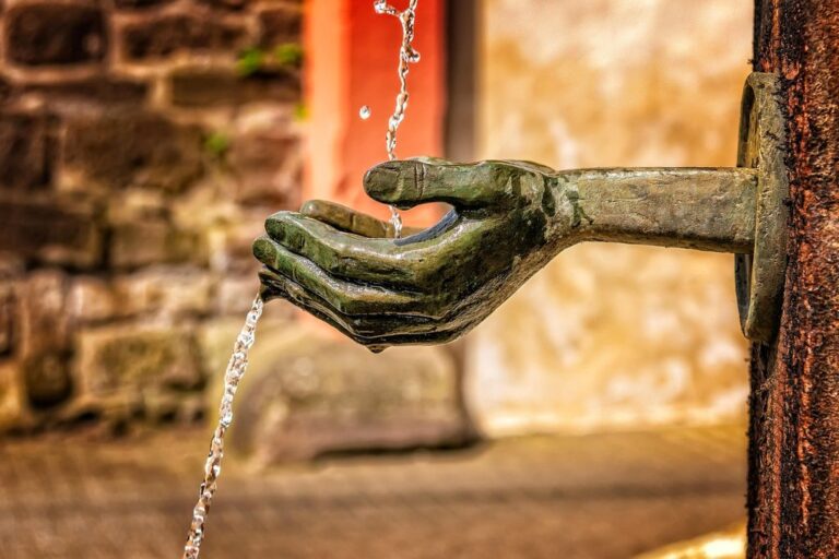 fountain water flow wet water feature nature lapping water jet hands close up drink refresh to clean symbol give take quiet power recover peaceful enjoy drops